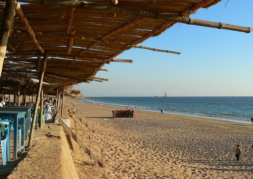 Thatched shade shelters line the sand at Manora Beach